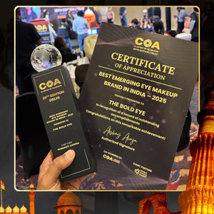 Certificate of Appreciation for 'Best Emerging Eye Makeup Brand in India' held in front of a blurred background with architectural elements.